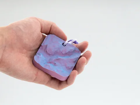 Real photo: Dawn keychain of Half Dome held in a hand