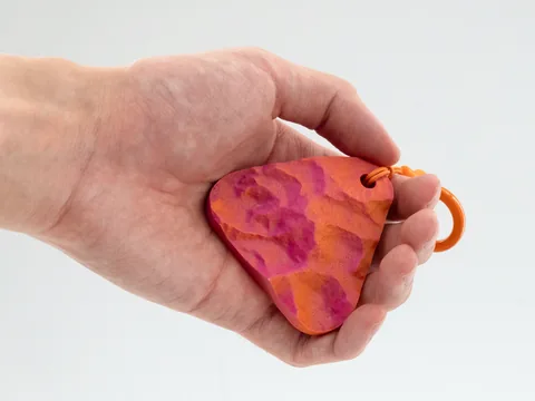 Real photo: Ember keychain of Denali held in a hand