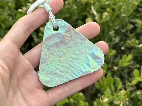 Real photo: a customer’s Sorbet keychain of Cades Cove held in a hand