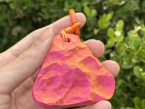 Real photo: Ember keychain of Denali held in a hand