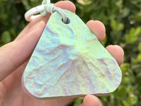 Real photo: Sorbet keychain of Mount Rainier National Park held in a hand